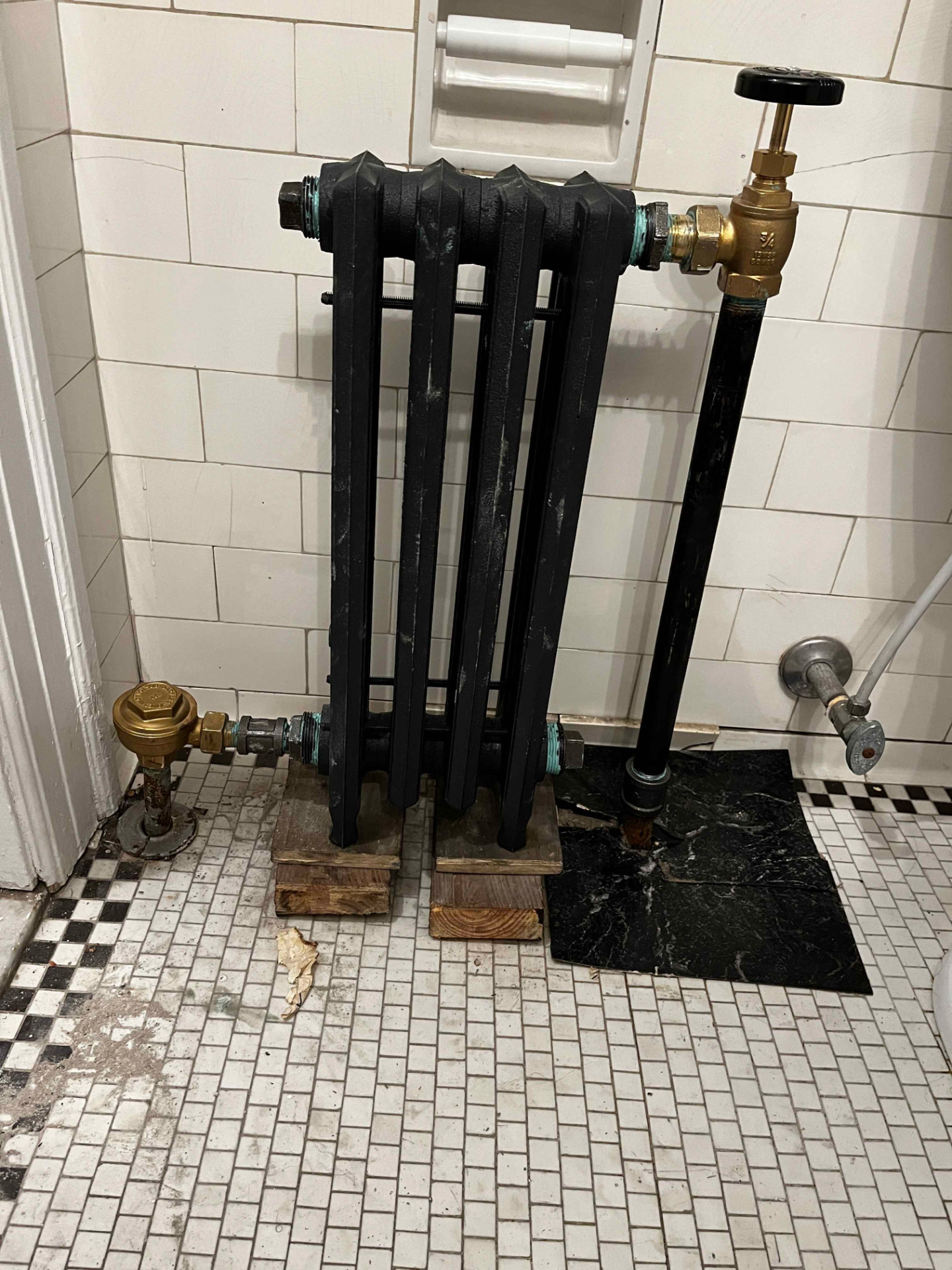 Bathroom radiator reinstall — Refinished cast-iron radiator with new valves